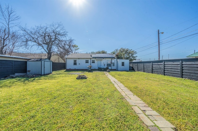 back of house with solar panels, a fenced backyard, an outdoor structure, and a shed