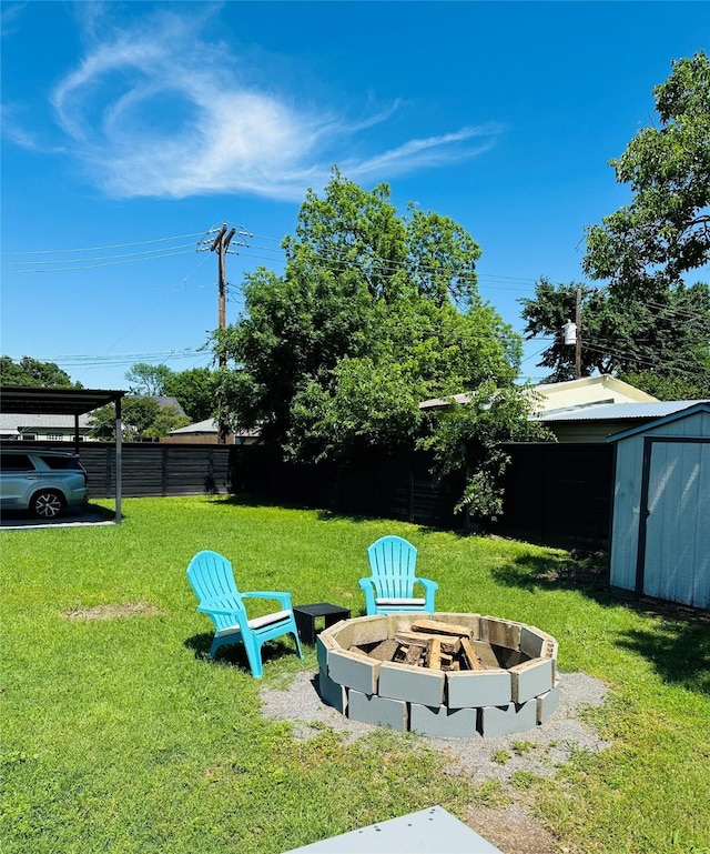 1216 Fuller Dr, Dallas, TX 75218 - view of yard with an outdoor fire pit, an outbuilding, fence, and a storage unit