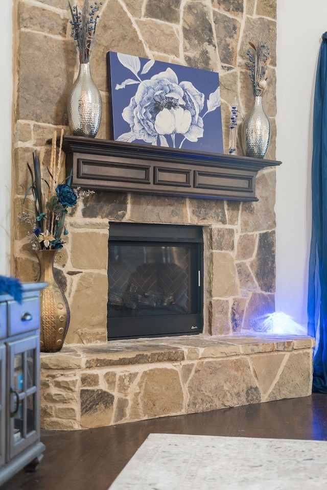 interior details with a fireplace and wood finished floors