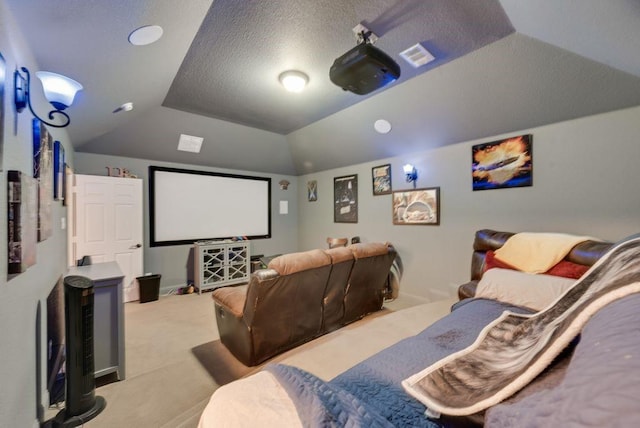 cinema room featuring carpet flooring, vaulted ceiling, visible vents, and a textured ceiling