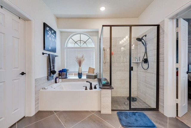 full bath with tile patterned flooring, a garden tub, and a shower stall