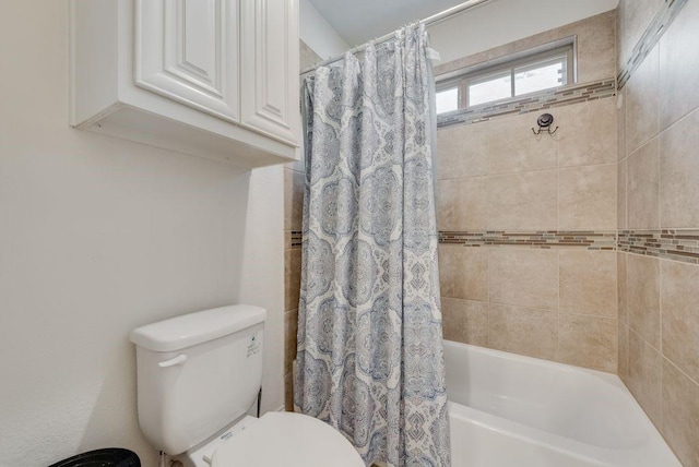 bathroom featuring toilet and shower / tub combo