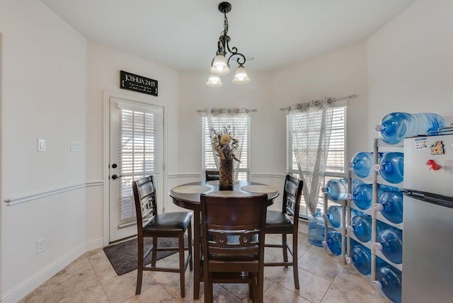 dining space featuring a chandelier, plenty of natural light, and light tile patterned floors