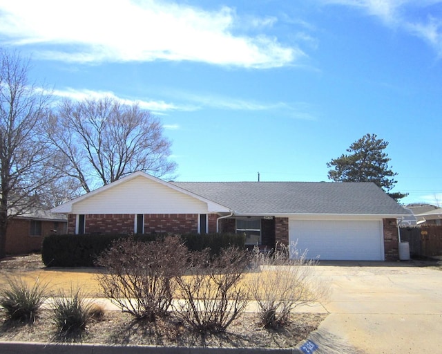 ranch-style home featuring a garage, brick siding, driveway, and a shingled roof