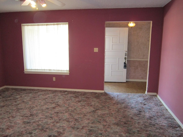 unfurnished room featuring ceiling fan, carpet flooring, and baseboards