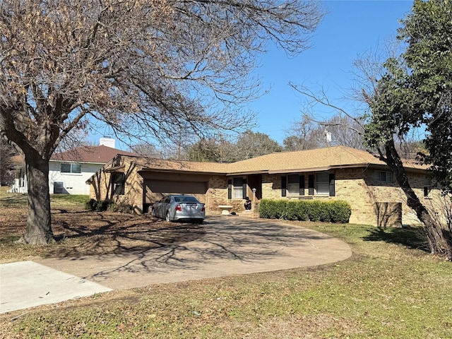 single story home with an attached garage, brick siding, and driveway