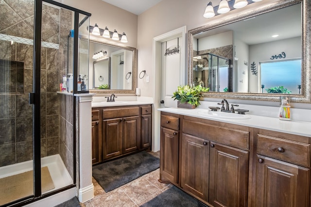 full bathroom featuring a stall shower, two vanities, a sink, and tile patterned flooring