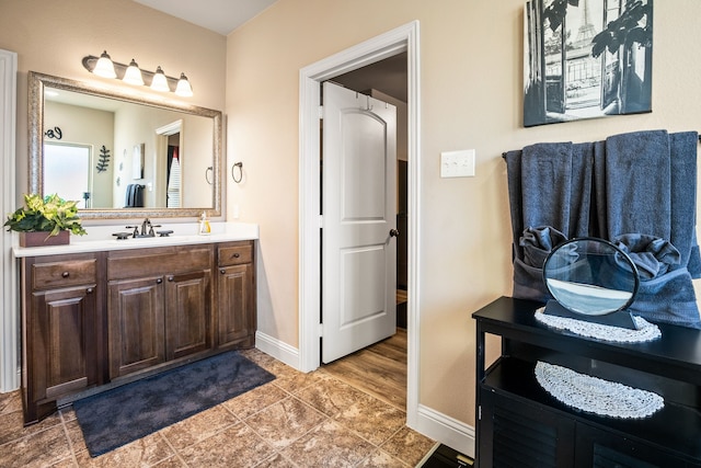 bathroom featuring vanity and baseboards