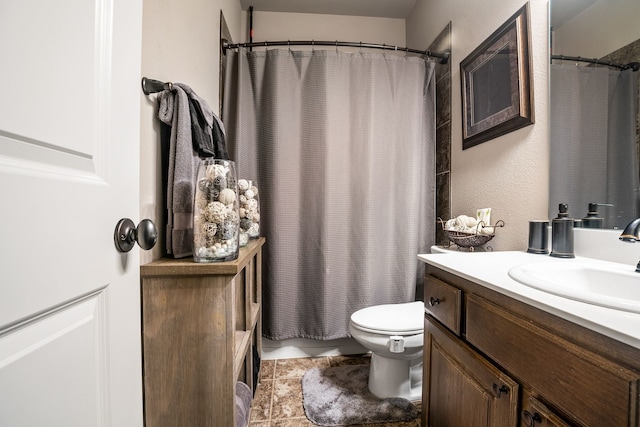 full bath with a shower with curtain, vanity, toilet, and tile patterned floors