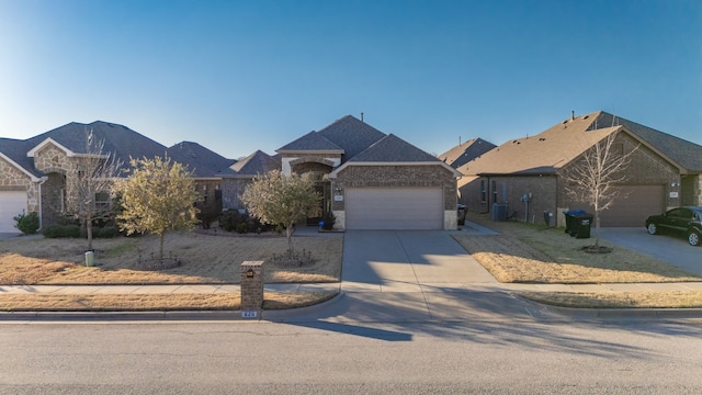 view of front of house featuring concrete driveway and an attached garage