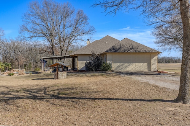 view of front facade featuring a garage, a shingled roof, dirt driveway, a chimney, and a front lawn