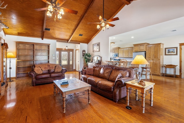 living area featuring high vaulted ceiling, wooden ceiling, beam ceiling, and light wood-style floors