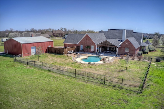 view of pool featuring a lawn, fence, a patio, and a pole building