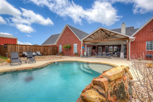 view of swimming pool with a patio, fence, and a fenced in pool