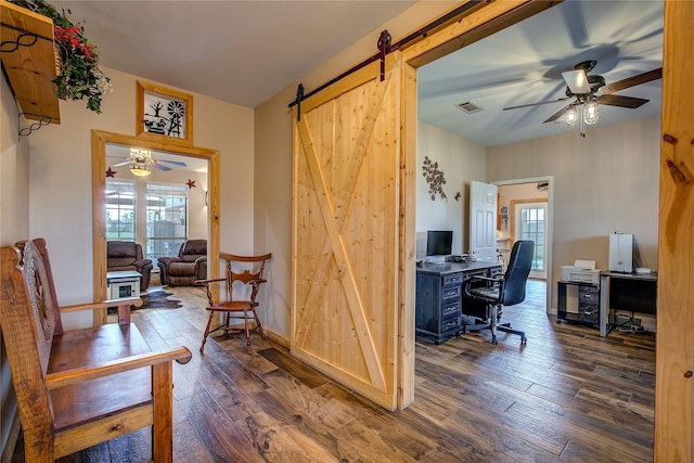 home office with ceiling fan, visible vents, plenty of natural light, and hardwood / wood-style floors