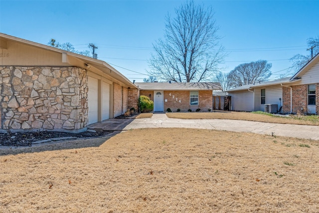 exterior space featuring stone siding and central air condition unit