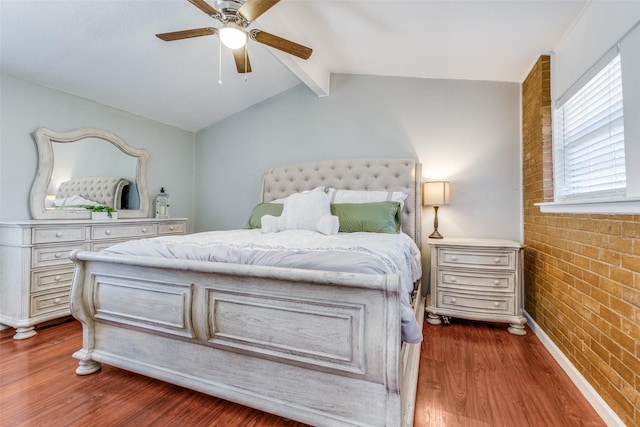 bedroom with baseboards, dark wood finished floors, lofted ceiling with beams, ceiling fan, and brick wall