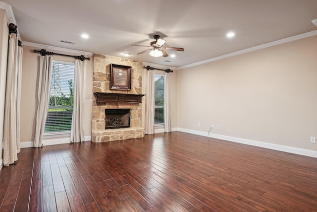 unfurnished living room featuring a fireplace, a ceiling fan, visible vents, dark wood-style floors, and crown molding