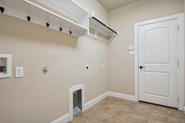 clothes washing area with hookup for a washing machine, hookup for an electric dryer, hookup for a gas dryer, laundry area, and baseboards