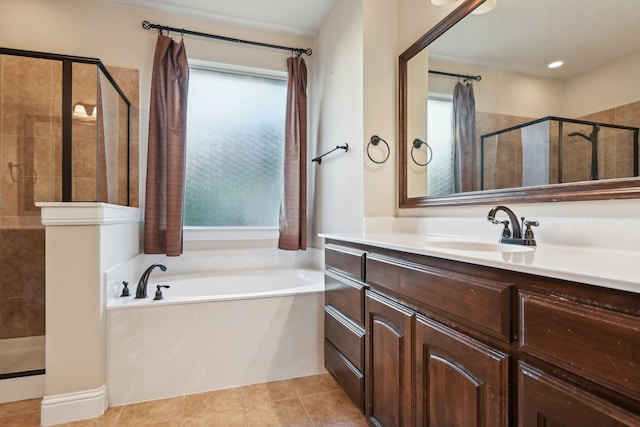 bathroom with a bath, vanity, tiled shower, and tile patterned floors