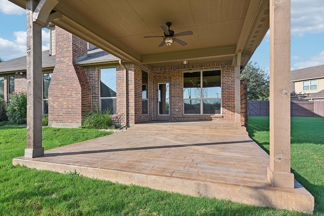 view of patio / terrace featuring ceiling fan and fence