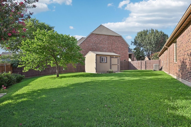 view of yard featuring an outbuilding, a storage unit, and a fenced backyard