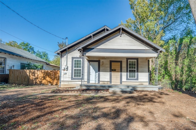 bungalow-style house featuring fence and a porch