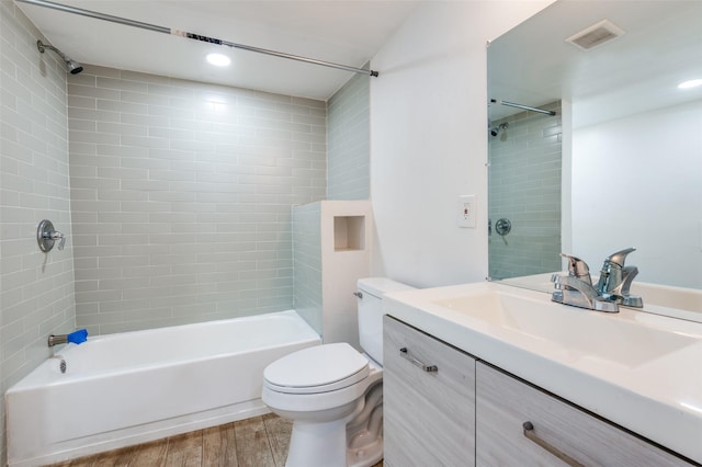 bathroom featuring shower / bathtub combination, visible vents, toilet, vanity, and wood finished floors