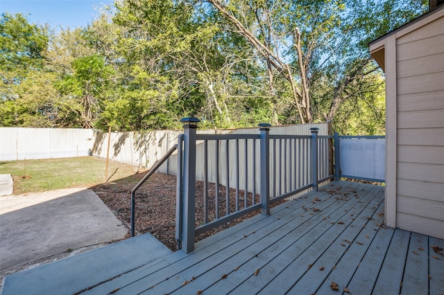 wooden terrace with a fenced backyard and a yard