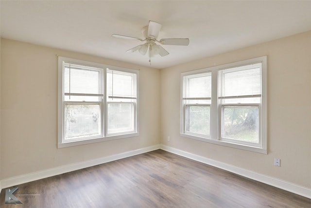 unfurnished room with dark wood-type flooring and baseboards