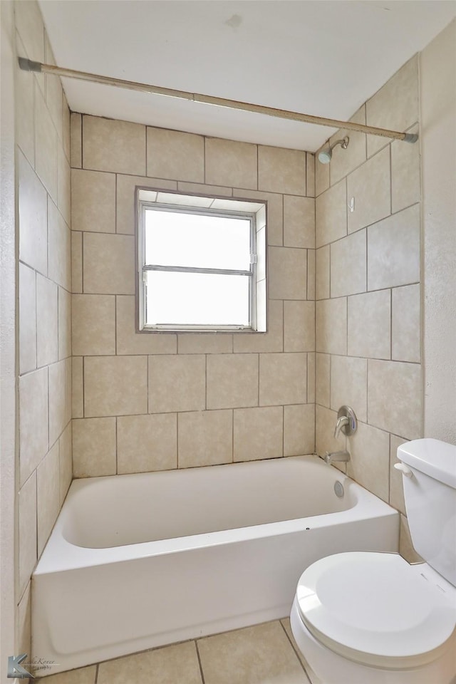 bathroom with toilet, tile patterned flooring, and bathing tub / shower combination