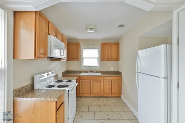 kitchen featuring light countertops, visible vents, light tile patterned flooring, a sink, and white appliances