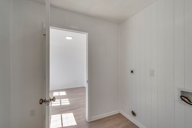 laundry area with hookup for a washing machine, hookup for an electric dryer, laundry area, baseboards, and light wood-style floors