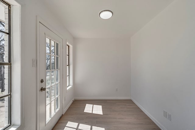 entryway with wood finished floors and baseboards