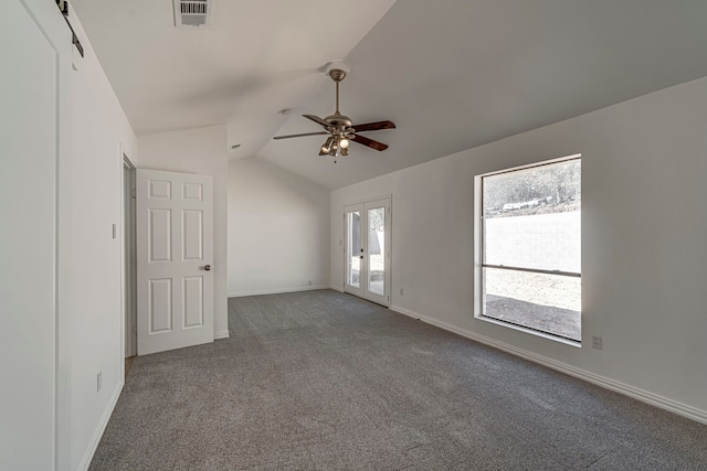 carpeted empty room featuring visible vents, vaulted ceiling, baseboards, and ceiling fan