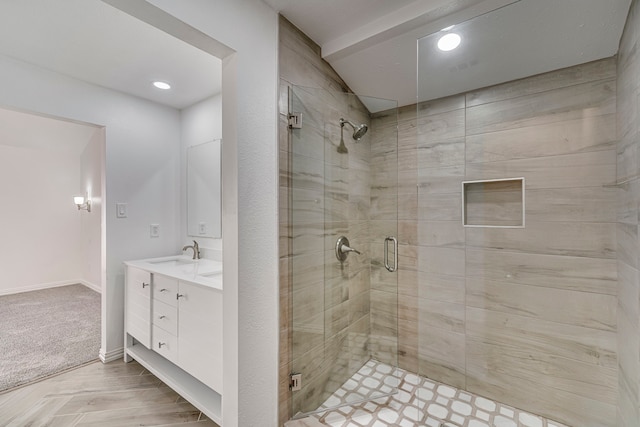 full bath with a stall shower, vanity, and baseboards