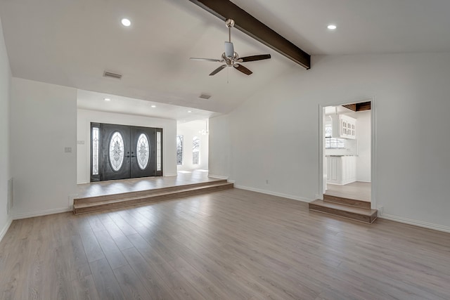 interior space with visible vents, lofted ceiling with beams, baseboards, and wood finished floors