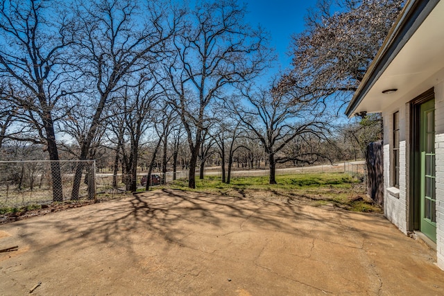 view of yard featuring fence and a patio