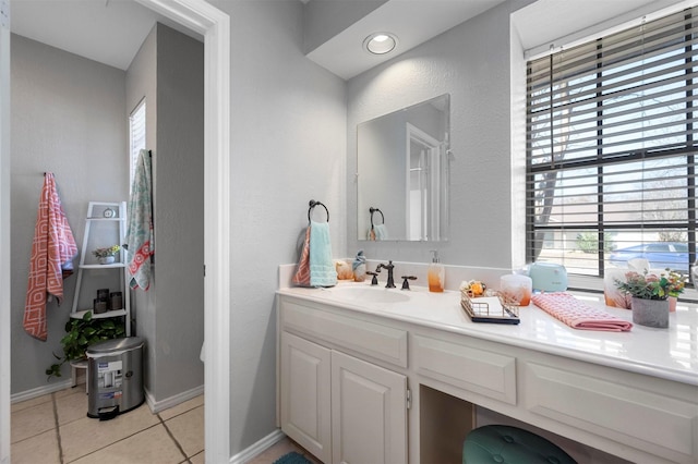 bathroom featuring baseboards, vanity, and tile patterned floors