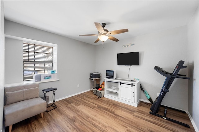 sitting room featuring ceiling fan, light wood finished floors, and baseboards