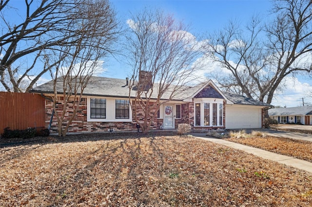 single story home featuring a garage, brick siding, fence, driveway, and a chimney