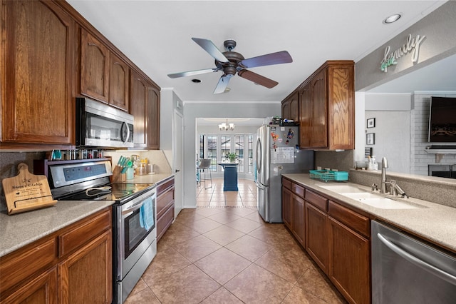 kitchen featuring light tile patterned flooring, stainless steel appliances, a sink, light countertops, and backsplash