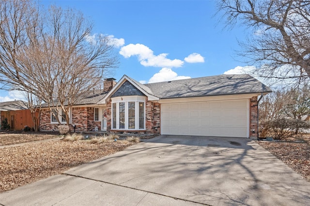 view of front of property with an attached garage, a chimney, concrete driveway, and brick siding