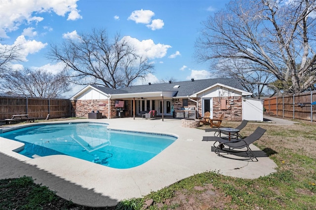 view of swimming pool with a fenced backyard, ceiling fan, a fenced in pool, and a patio