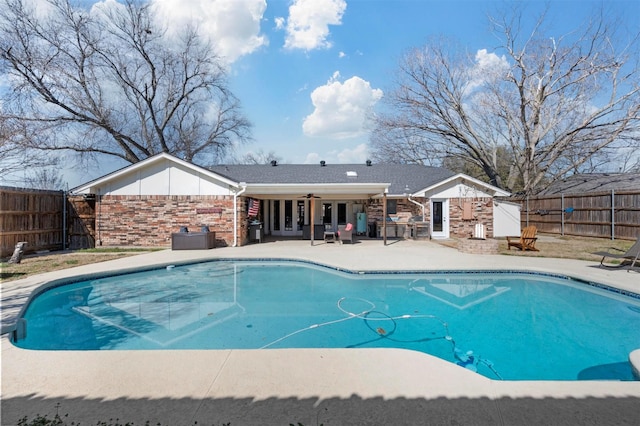 view of swimming pool with a patio, a fenced backyard, a ceiling fan, and a fenced in pool