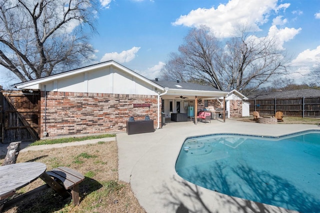 view of swimming pool featuring a fenced backyard, a fenced in pool, a ceiling fan, and a patio