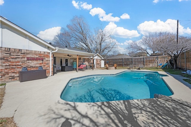 view of pool with a patio area, a fenced backyard, a fenced in pool, and a ceiling fan