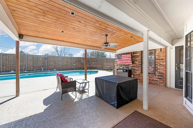 view of patio / terrace featuring a fenced in pool, a fenced backyard, and ceiling fan