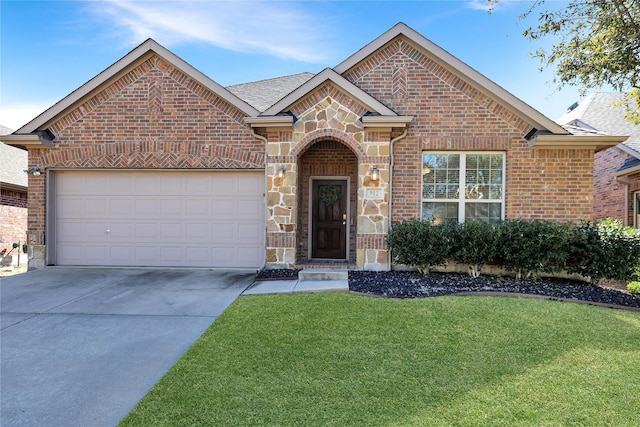 view of front of house featuring driveway, a garage, stone siding, a front lawn, and brick siding