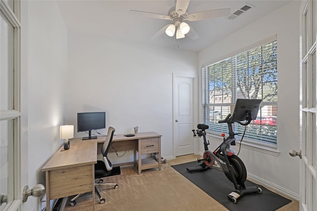 carpeted office with ceiling fan, visible vents, and baseboards